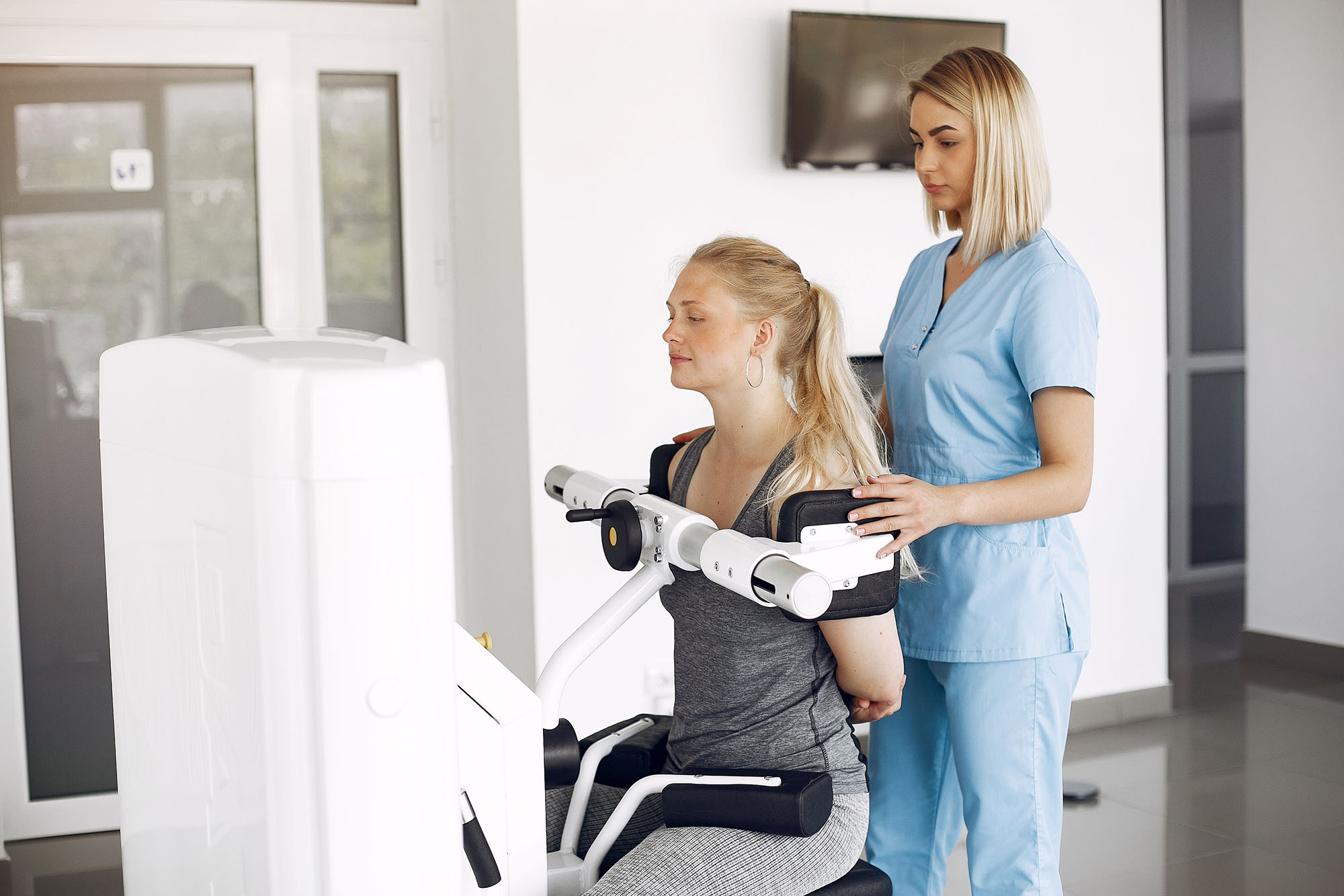 A woman making physical therapy exercises with a qualified physiotherapy therapist